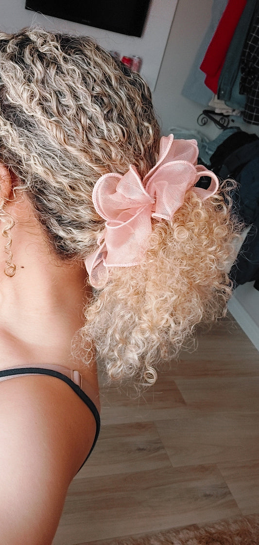 Close-up of 3A curls tied back with soft accessory after detangling routine