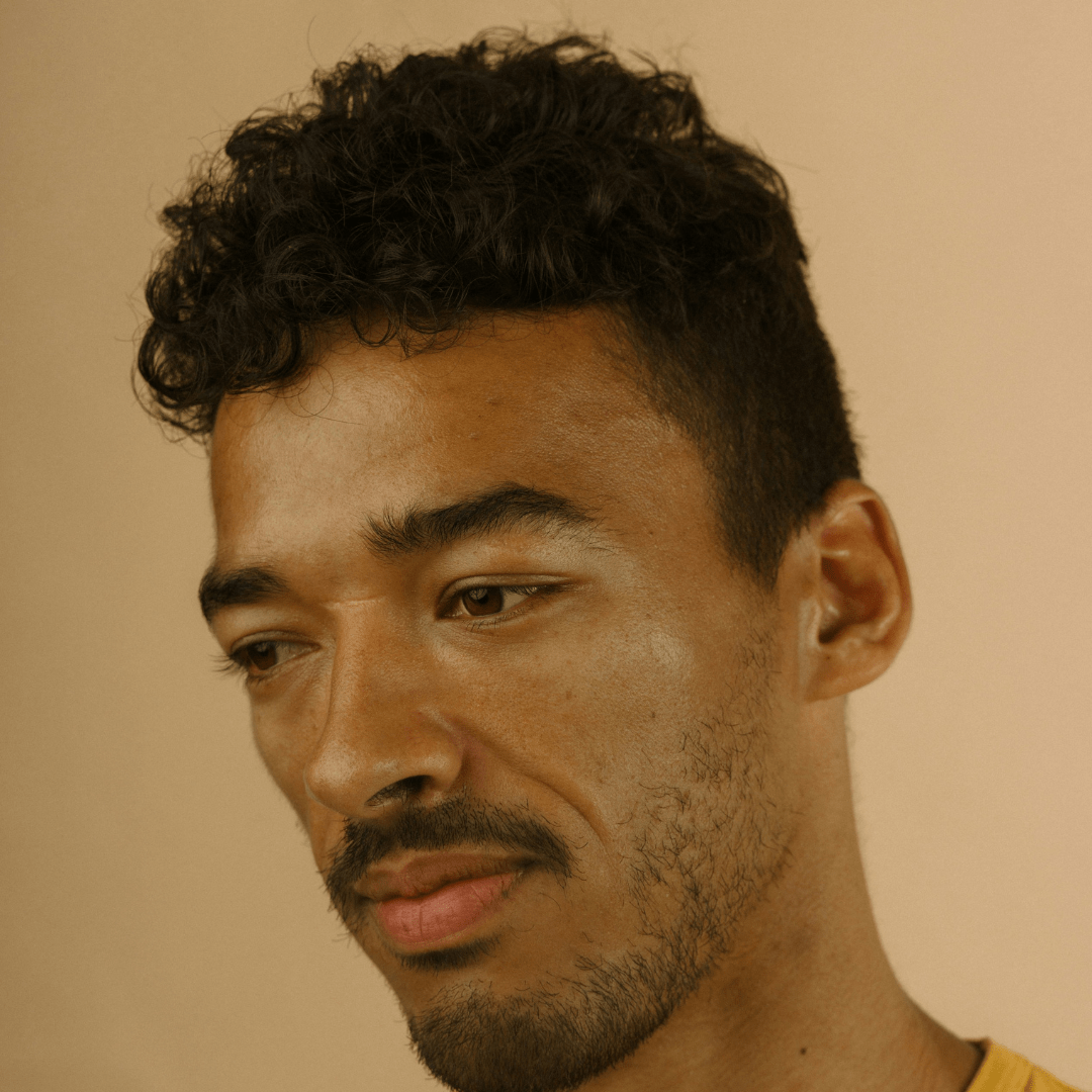 Close-up of well-maintained curls on man, highlighting balanced hair care routine
